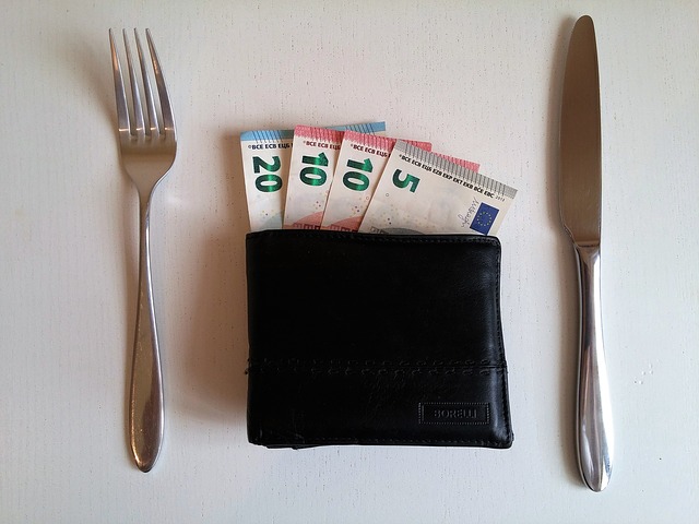 Wallet on a dinner table. Money is showing from the wallet. What is the value of food?