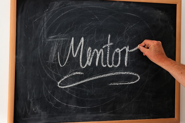 A chalkboard with the word mentor written on it in chalk. The article is about how to get a mentor. Finding Mentors