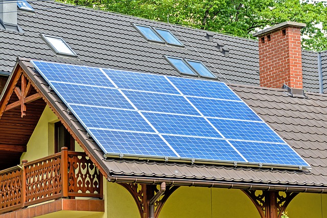 A house with solar panels on it. The article is about SolarCity and Tesla. The future of the grid will probably be solar panels using batteries and electric vehicles. 