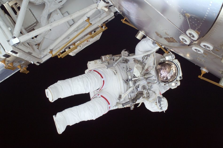 An Astronaut floating in space next to a space craft. The Astronaut is in a space suit and is almost horizontal. Dream Job, Career advice 